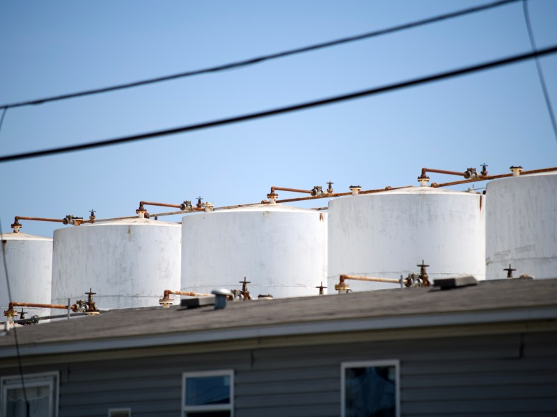 A row of tanks looms above an office building at K-Solv’s chemical distribution facility.