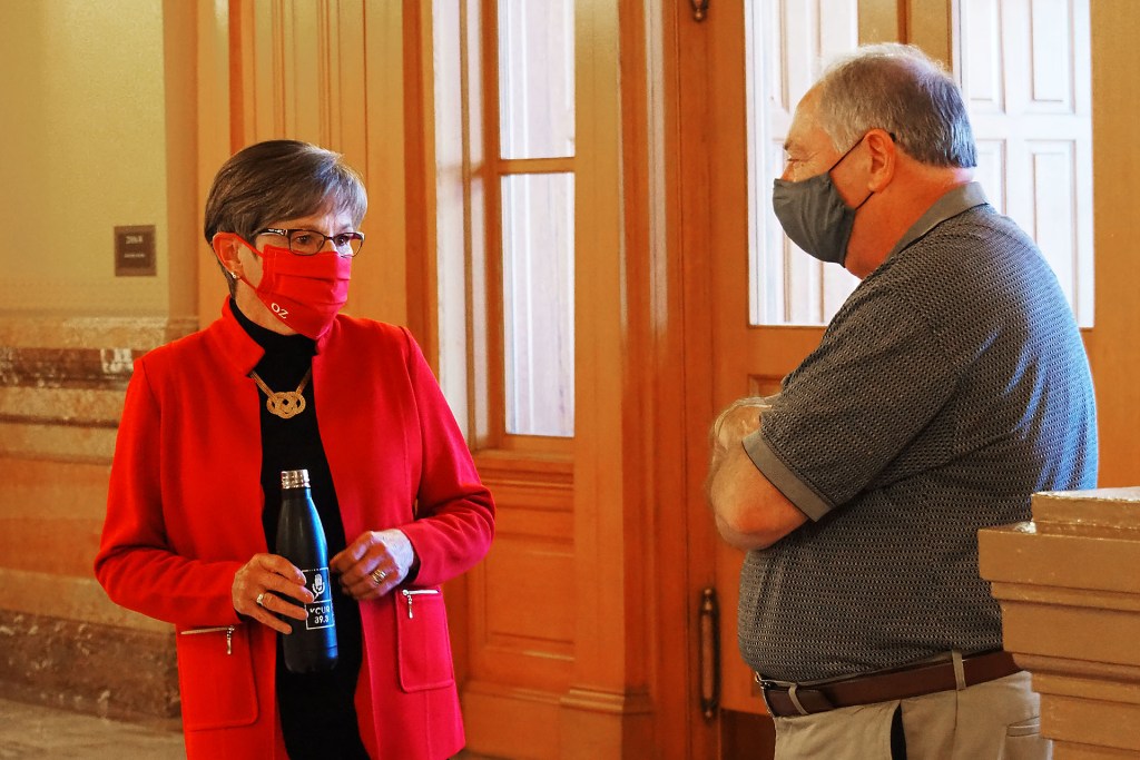 Gov. Laura Kelly, a Topeka Democrat, speaks at the Capitol with Jim Denning, then the Senate majority leader, in October 2020.