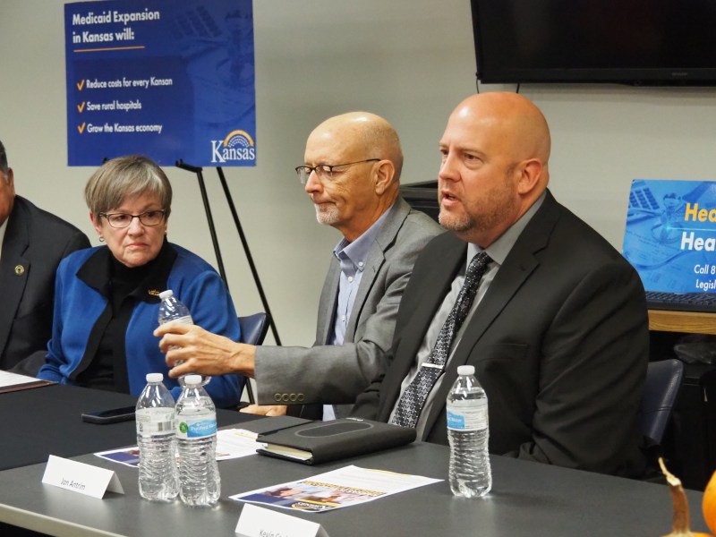 Gov. Laura Kelly, left, listens to a discussion about the advantage of expanding eligibility for Medicaid to lower-income Kansans as 40 states have done since 2014.