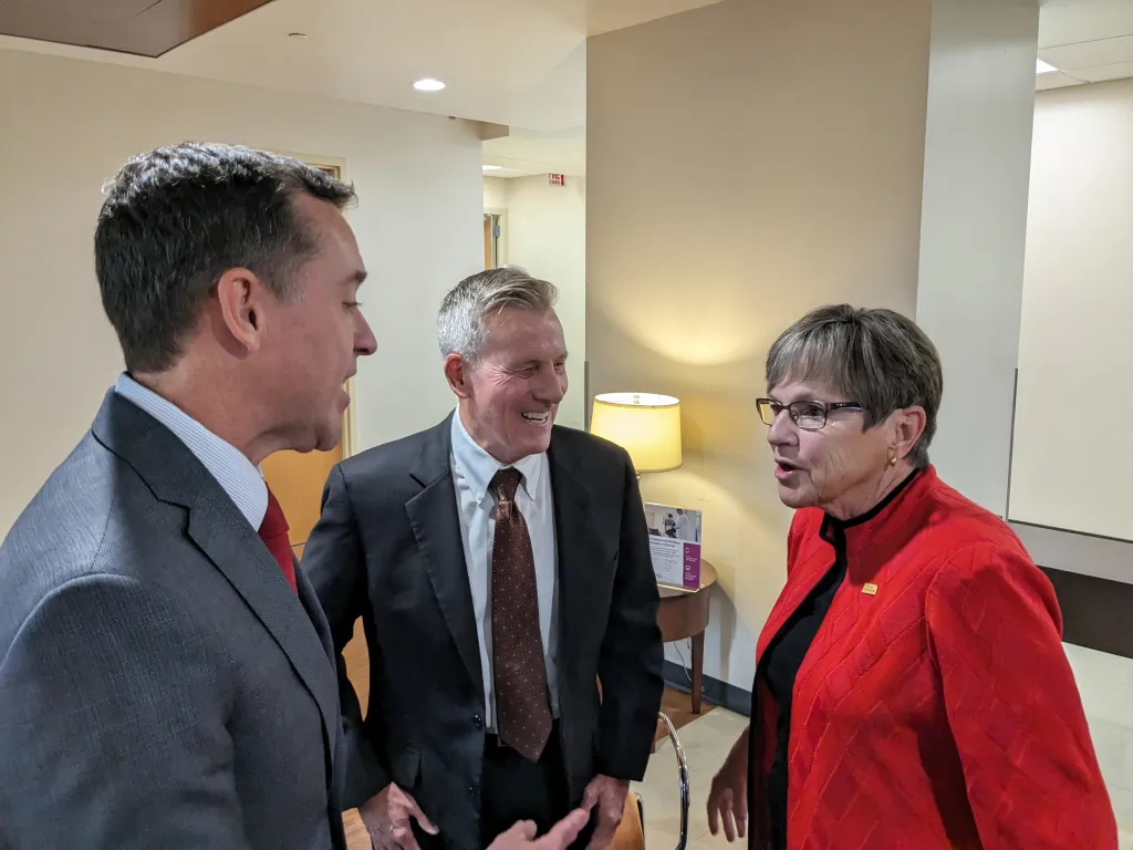 Blake Benson, board chairman of Ascension Via Christi Hospital in Pittsburg (left), and Dennis Franks, CEO of Neosho Memorial Regional Medical Center in Chanute, speak in October with Gov. Laura Kelly about expanding Medicaid coverage.