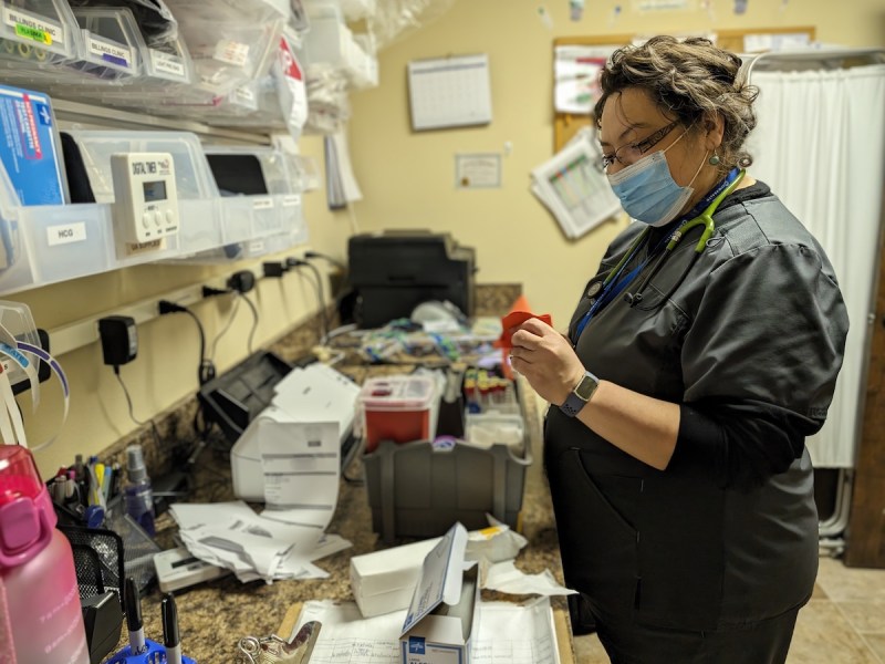 Julia Carrasco straightens out equipment for blood work at the One Health community health center in downtown Powell.