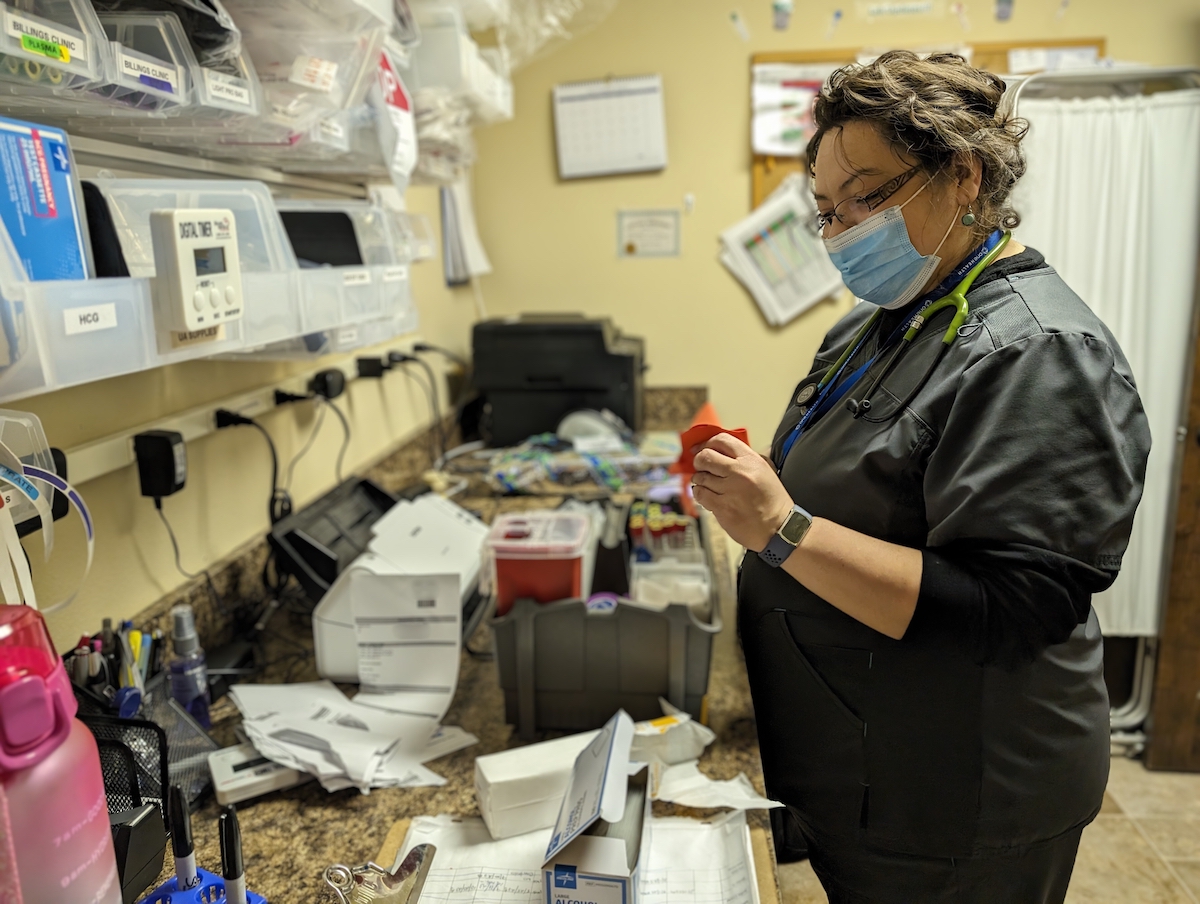 Julia Carrasco straightens out equipment for blood work at the One Health community health center in downtown Powell.