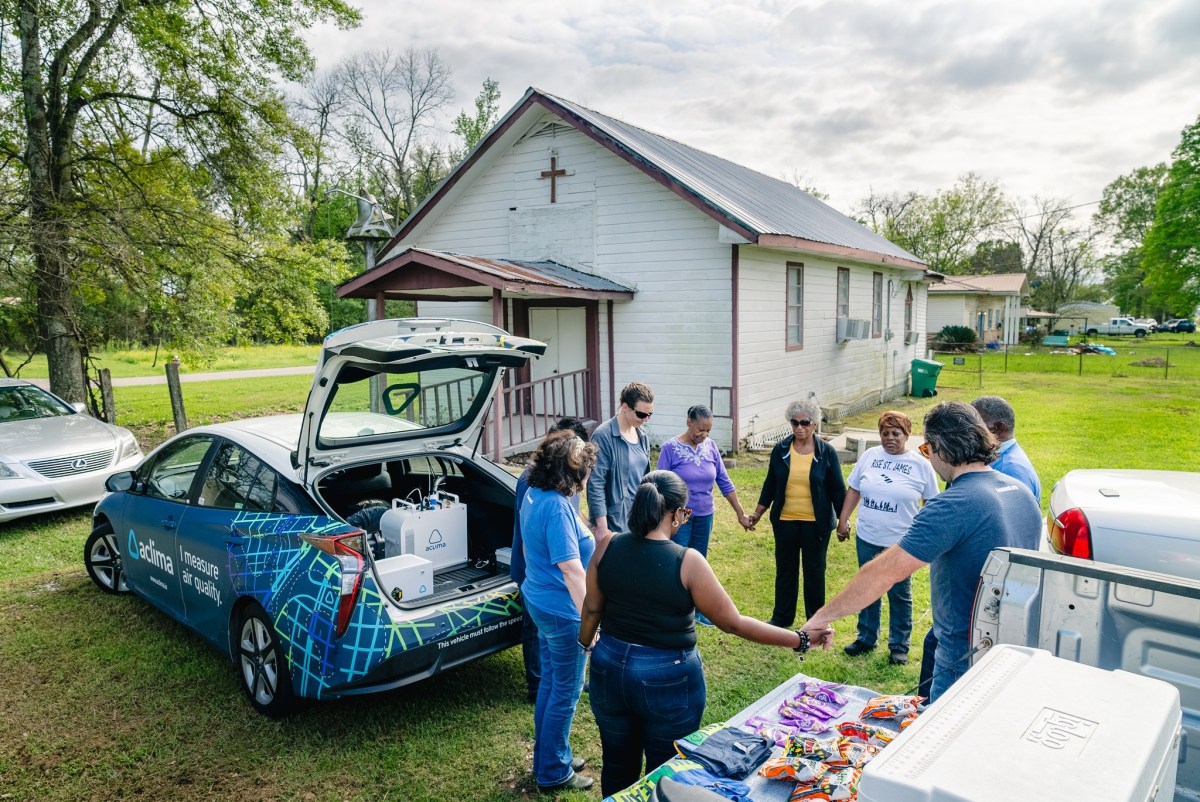 Pastor Harry Joseph leads community members, members of the Louisiana Environmental Action Network and Aclima scientist Aja Ellis in prayer on March 16, 2024.