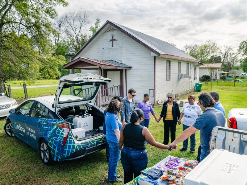 Pastor Harry Joseph leads community members, members of the Louisiana Environmental Action Network and Aclima scientist Aja Ellis in prayer on March 16, 2024.